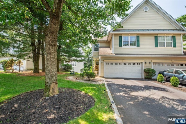 90 Warbler Dr, Wayne, NJ 07470 - view of front facade with driveway, a standing seam roof, an attached garage, a metal roof, and a front yard
