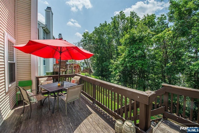 90 Warbler Dr, Wayne, NJ 07470 - wooden terrace featuring outdoor dining area