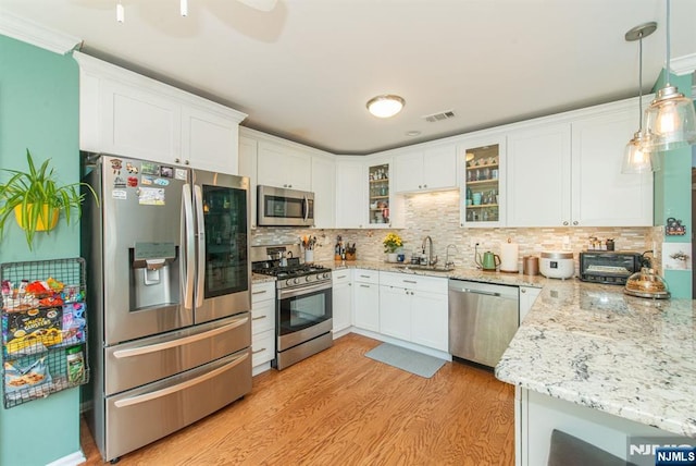 90 Warbler Dr, Wayne, NJ 07470 - kitchen featuring appliances with stainless steel finishes, light wood finished floors, and white cabinetry