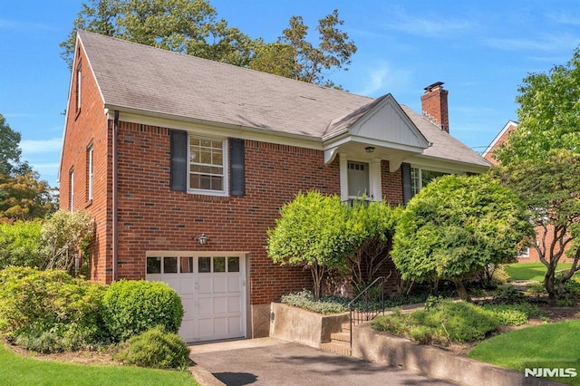 33 Ravine Dr, Hawthorne, NJ 07506 - view of front of house featuring an attached garage, brick siding, asphalt driveway, a chimney, and roof with shingles