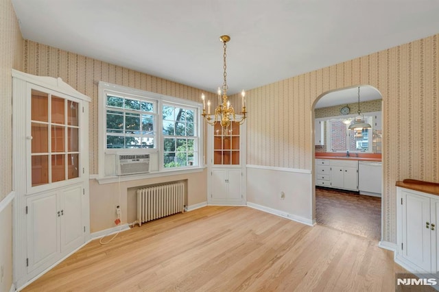 33 Ravine Dr, Hawthorne, NJ 07506 - unfurnished dining area with radiator heating unit, wallpapered walls, light wood-type flooring, a chandelier, and cooling unit