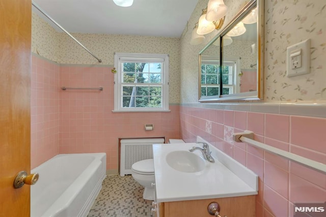33 Ravine Dr, Hawthorne, NJ 07506 - bathroom featuring radiator heating unit, vanity, shower / tub combination, a wainscoted wall, and wallpapered walls