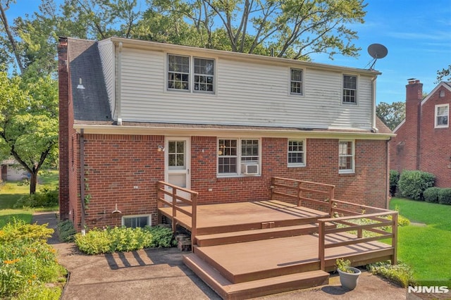 33 Ravine Dr, Hawthorne, NJ 07506 - back of house with brick siding, a wooden deck, and a lawn