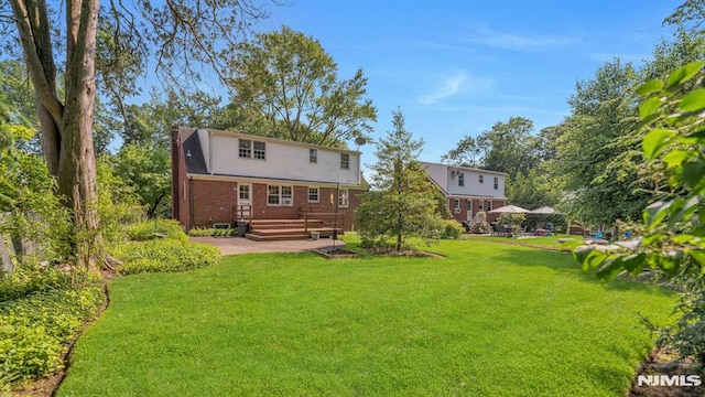 33 Ravine Dr, Hawthorne, NJ 07506 - rear view of property featuring brick siding, a yard, a patio area, and a deck