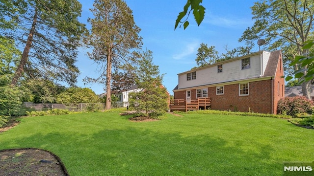 33 Ravine Dr, Hawthorne, NJ 07506 - back of property featuring a deck and brick siding