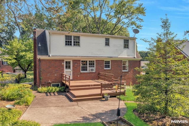 33 Ravine Dr, Hawthorne, NJ 07506 - rear view of property with brick siding, a deck, a patio area, and a chimney