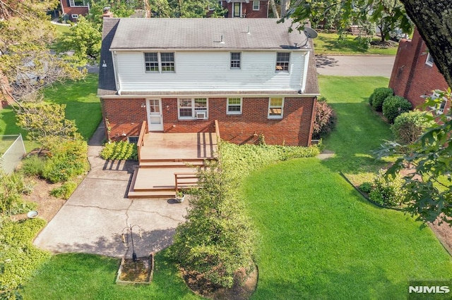 33 Ravine Dr, Hawthorne, NJ 07506 - rear view of house with a wooden deck, brick siding, and a lawn
