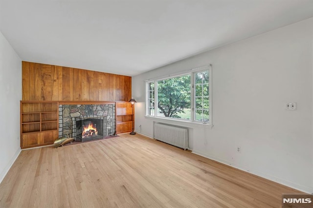 33 Ravine Dr, Hawthorne, NJ 07506 - unfurnished living room featuring radiator heating unit, wood finished floors, and a fireplace