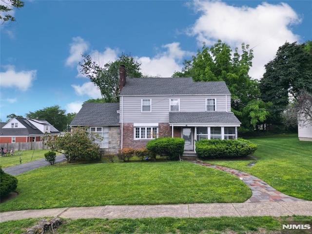 16 Vandelinda Ave, Teaneck, NJ 07666 - view of front of home featuring a chimney, stone siding, and a shingled roof