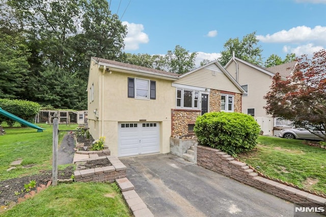 363 Amherst St, Wyckoff, NJ 07481 - view of front of property featuring an attached garage, asphalt driveway, stone siding, stucco siding, and a playground