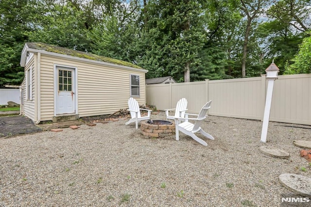 363 Amherst St, Wyckoff, NJ 07481 - view of yard featuring a fire pit, an outbuilding, and view of wooded area