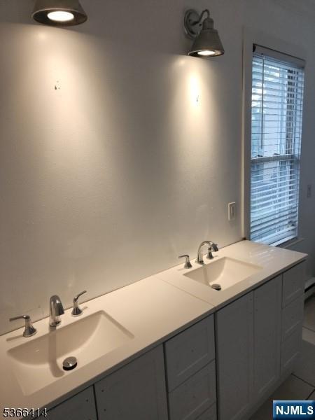 34 Voorhees St, Newark, NJ 07108 - bathroom featuring tile patterned floors and double vanity