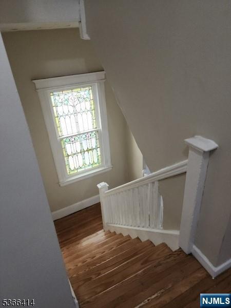 34 Voorhees St, Newark, NJ 07108 - stairs featuring wood finished floors and baseboards