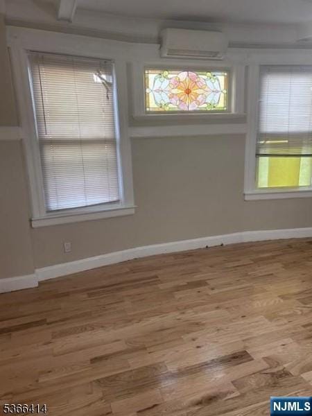 34 Voorhees St, Newark, NJ 07108 - empty room featuring a wall mounted air conditioner and wood finished floors