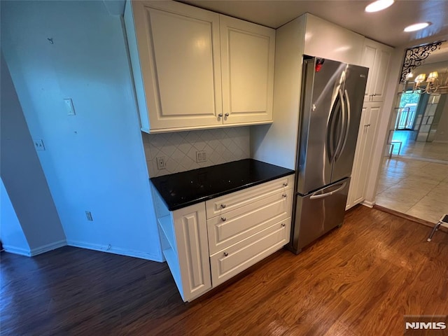 245 Prospect Ave Unit 5A, Hackensack, NJ 07601 - kitchen featuring freestanding refrigerator, dark countertops, dark wood finished floors, and white cabinets