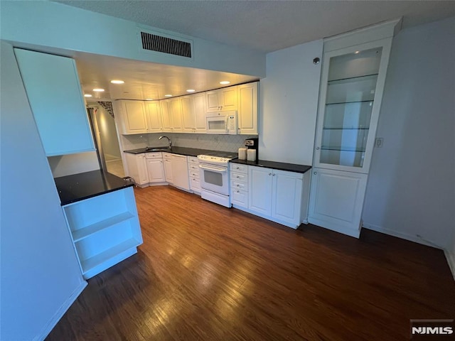 245 Prospect Ave Unit 5A, Hackensack, NJ 07601 - kitchen with white appliances, dark wood-style floors, dark countertops, and white cabinets