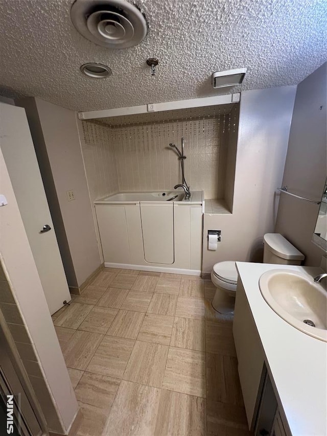 245 Prospect Ave Unit 5A, Hackensack, NJ 07601 - bathroom with vanity, a garden tub, and a textured ceiling