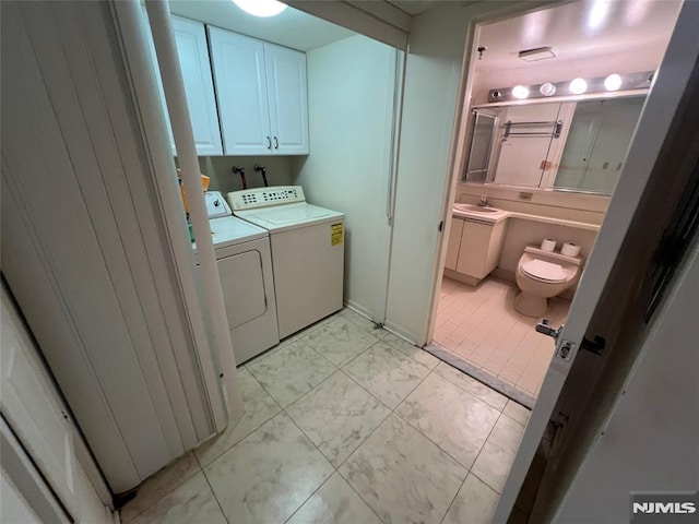245 Prospect Ave Unit 5A, Hackensack, NJ 07601 - laundry room featuring washing machine and clothes dryer, light marble finish flooring, and cabinet space