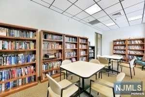 245 Prospect Ave Unit 5A, Hackensack, NJ 07601 - sitting room featuring wall of books and a paneled ceiling