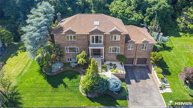44 Columbus Ave, Totowa, NJ 07512 - view of front of property featuring a balcony, a chimney, a garage, and a front yard
