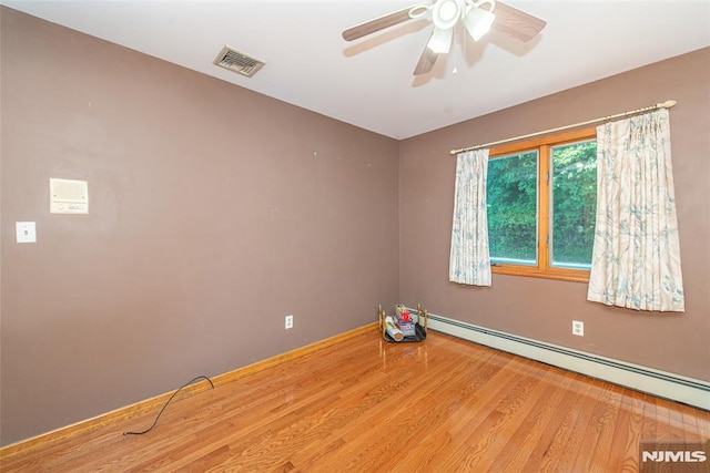 44 Columbus Ave, Totowa, NJ 07512 - empty room featuring a baseboard radiator, wood finished floors, and a ceiling fan