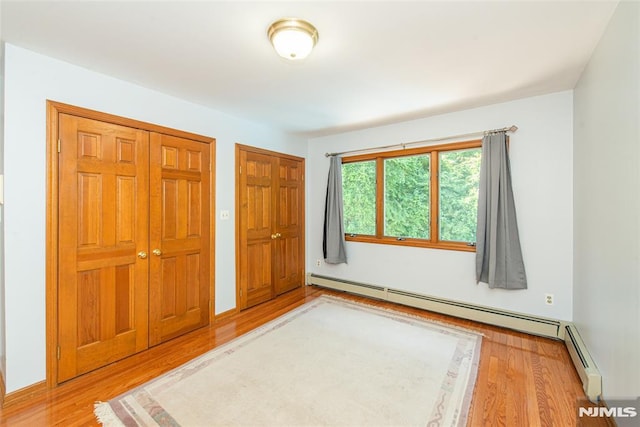 44 Columbus Ave, Totowa, NJ 07512 - unfurnished bedroom with wood finished floors and a baseboard heating unit