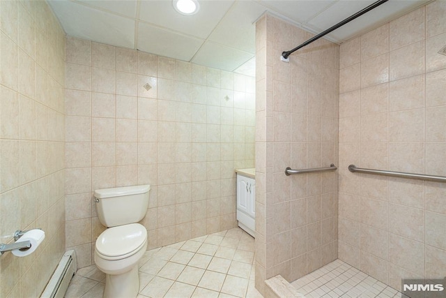 44 Columbus Ave, Totowa, NJ 07512 - full bathroom featuring a tile shower, tile walls, a baseboard heating unit, and tile patterned floors
