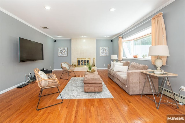 44 Columbus Ave, Totowa, NJ 07512 - living room with crown molding, wood finished floors, recessed lighting, a tile fireplace, and a baseboard heating unit