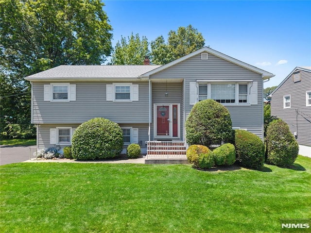 87 Larkspur Ln, Clifton, NJ 07013 - raised ranch featuring a front yard and a chimney