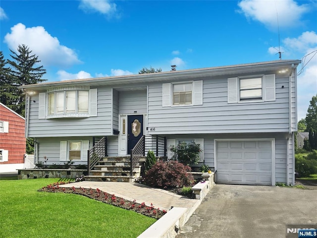 416 Magnolia Ave, Pompton Lakes, NJ 07442 - bi-level home with an attached garage, a front yard, and asphalt driveway