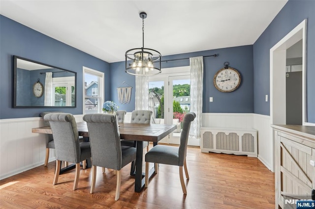 862 Lafayette Ave Extension, Hawthorne, NJ 07506 - dining space with a chandelier, a wainscoted wall, radiator, wood finished floors, and a decorative wall