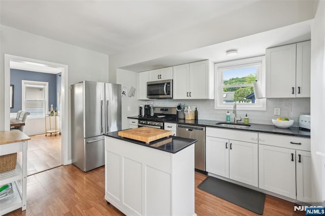 862 Lafayette Ave Extension, Hawthorne, NJ 07506 - kitchen with appliances with stainless steel finishes, dark countertops, backsplash, and light wood-style flooring