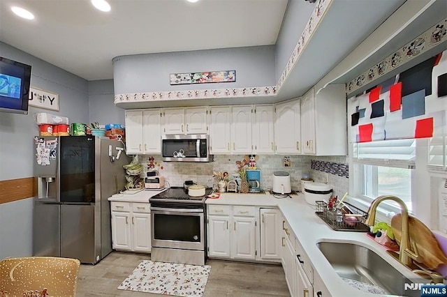 299 7th Ave, Newark, NJ 07107 - kitchen featuring appliances with stainless steel finishes, white cabinetry, light wood finished floors, and recessed lighting