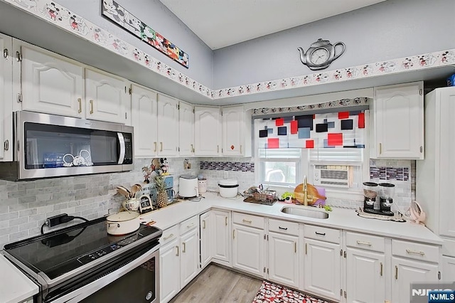 299 7th Ave, Newark, NJ 07107 - kitchen featuring electric range, stainless steel microwave, decorative backsplash, and light countertops