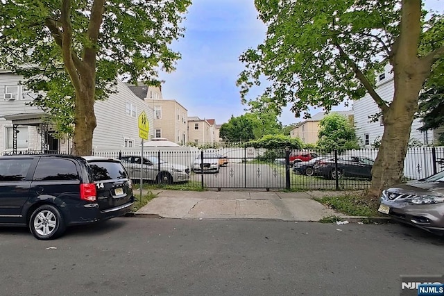 299 7th Ave, Newark, NJ 07107 - view of front of house featuring a residential view, uncovered parking, and a gate