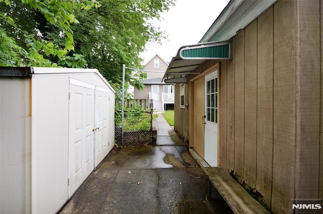 39 Mozart St, East Rutherford, NJ 07073 - view of side of home with a storage unit and a patio area
