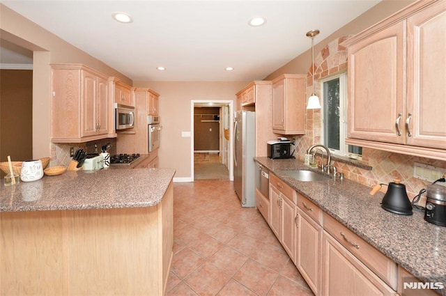 39 Mozart St, East Rutherford, NJ 07073 - kitchen featuring light brown cabinetry, appliances with stainless steel finishes, tasteful backsplash, light tile patterned floors, and hanging light fixtures