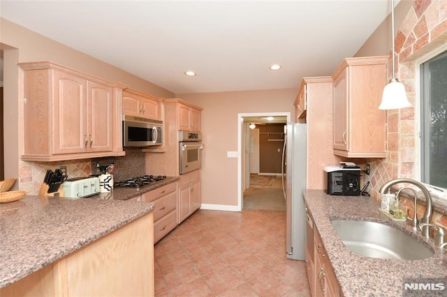 39 Mozart St, East Rutherford, NJ 07073 - kitchen featuring light brown cabinetry, stainless steel appliances, decorative backsplash, and recessed lighting