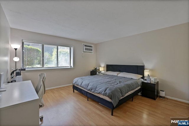462 Liberty St Unit 109, Little Ferry, NJ 07643 - bedroom featuring light wood-style flooring, a wall mounted air conditioner, and a desk