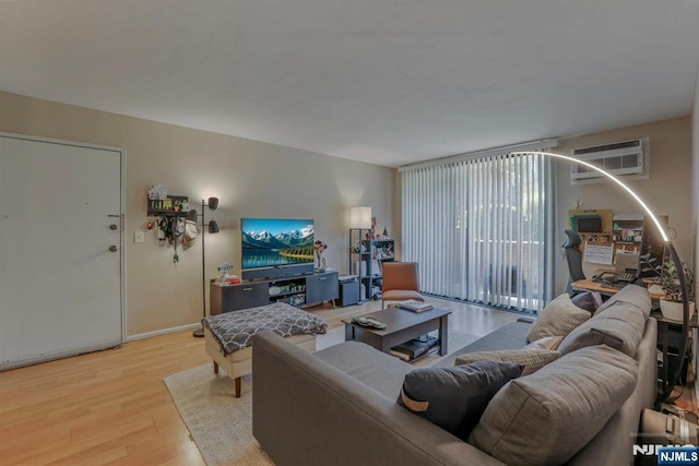462 Liberty St Unit 109, Little Ferry, NJ 07643 - living area featuring a wall mounted air conditioner and light wood-type flooring