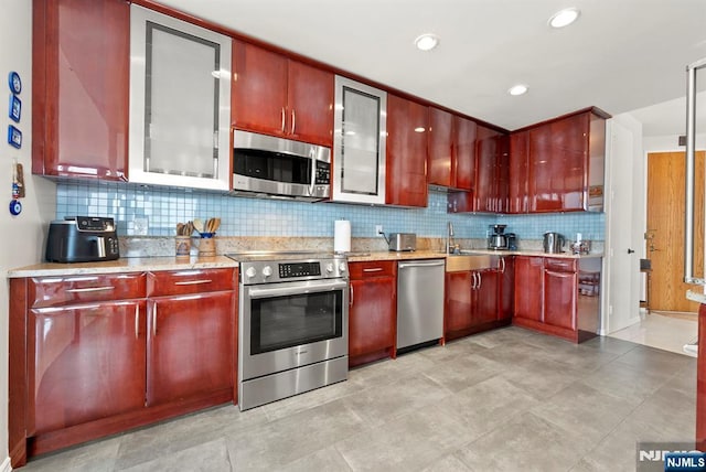 100 Carlyle Dr Unit 12K-S, Cliffside Park, NJ 07010 - kitchen featuring stainless steel appliances, dark brown cabinets, backsplash, and recessed lighting