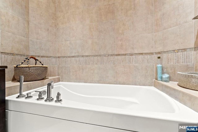 100 Carlyle Dr Unit 12K-S, Cliffside Park, NJ 07010 - bathroom featuring tile walls and a garden tub