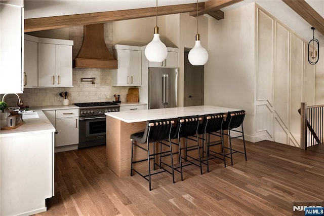 505 Darby Ct, Ridgewood, NJ 07450 - kitchen featuring premium appliances, premium range hood, decorative backsplash, dark wood finished floors, and a breakfast bar