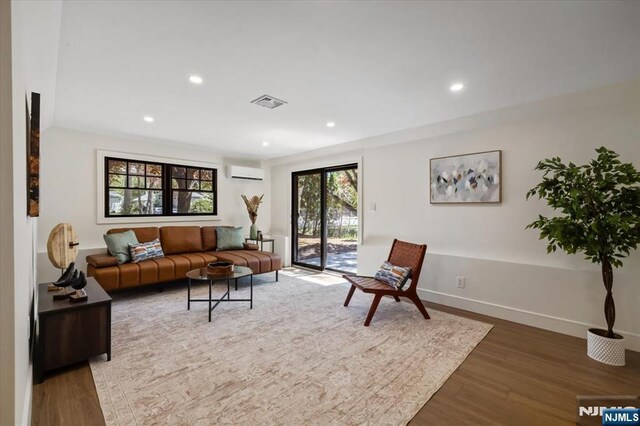 505 Darby Ct, Ridgewood, NJ 07450 - living room with a wall unit AC, wood finished floors, and recessed lighting