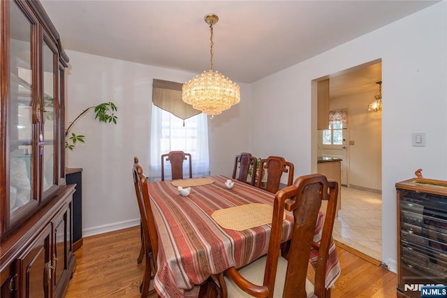 55 Rowland Ave, Hackensack, NJ 07601 - dining room featuring wine cooler, a chandelier, and light wood-style floors