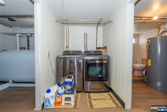 55 Rowland Ave, Hackensack, NJ 07601 - washroom featuring gas water heater, separate washer and dryer, wood finished floors, and oil tank