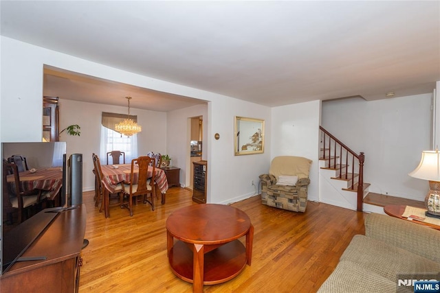 55 Rowland Ave, Hackensack, NJ 07601 - living area with light wood-style flooring, a chandelier, and stairway