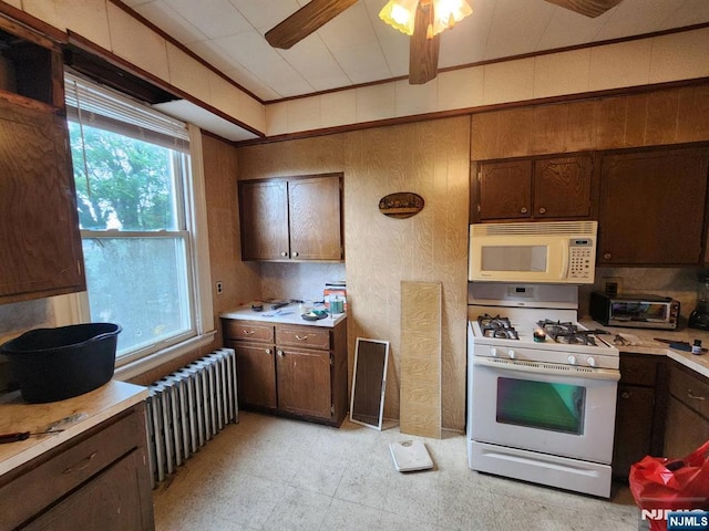 4311 Cottage Ave, North Bergen, NJ 07047 - kitchen featuring white appliances, radiator, light countertops, and dark brown cabinetry