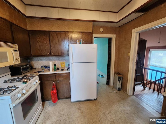 4311 Cottage Ave, North Bergen, NJ 07047 - kitchen with white appliances, light countertops, light floors, and tasteful backsplash