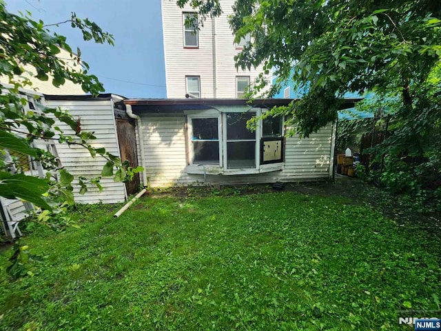 4311 Cottage Ave, North Bergen, NJ 07047 - back of house featuring a yard